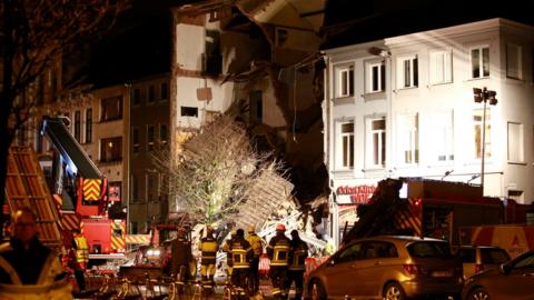 Firefighters inspect the debris, at the Paardenmarkt in Antwerp, Belgium after several buildings collapsed following an explosion