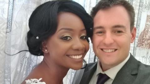 Zanele and Jamie smile for the camera on their wedding day