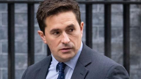 Johnny Mercer walking along Downing St