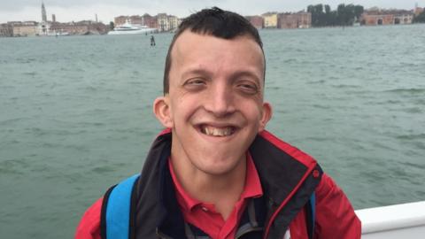 Young man with Noonan syndrome on a boat