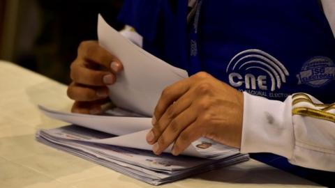 Members of Ecuador"s National Electoral Council (CNE) recount the votes of the April 2 runoff election, at the RumiÃ±ahui Coliseum in Quito on April 18, 2017