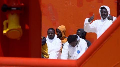 Migrants on board the tug boat