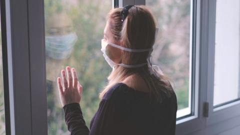 woman looking out of window