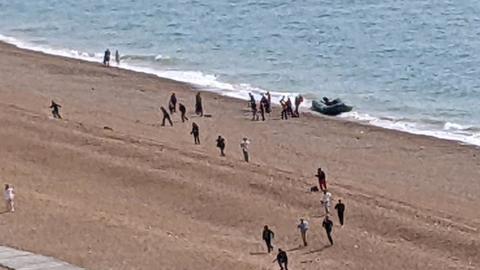 People arriving on the beach at Folkestone by boat