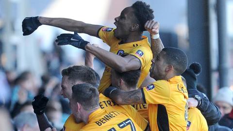 Newport players celebrate FA Cup success against Leeds in 2018