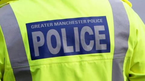 Stock shot of the back of a Greater Manchester Police officer