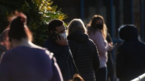 Man in a mask on the phone