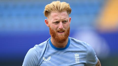 Ben Stokes warms up for an England match