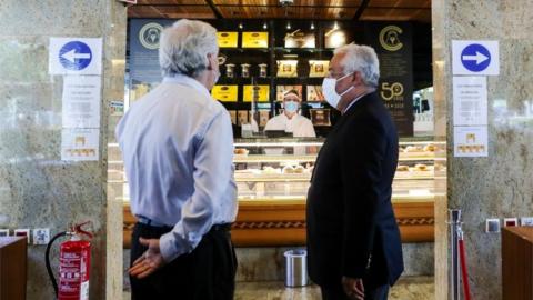 Antonio Costa (R) during breakfast at a pastry shop in Lisbon