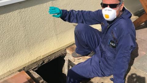 Dr Rob Verkerk heading into the underfloor void of one of the houses to inspect the monitoring stations