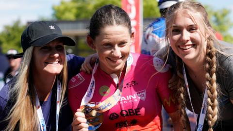 Lauren Parker after winning the Ironman 70.3 World Championship, with nurses Marci Nell and Sydnee Slack