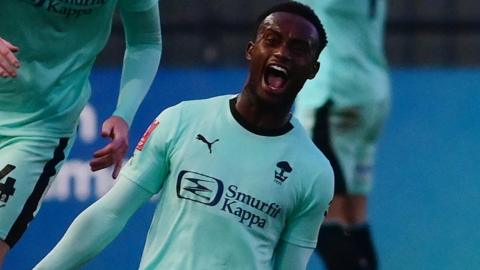 Steven Sessegnon celebrates scoring for Wigan at Exeter