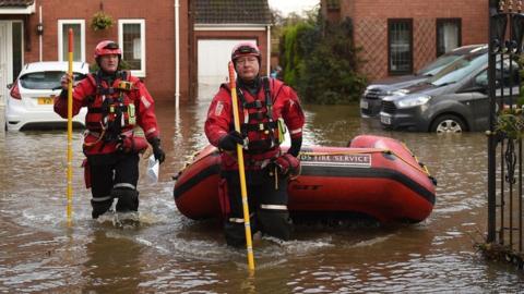 Members of the fire and rescue service work in the village of Fishlake, near Doncaster