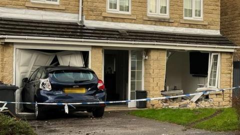 The damaged house and a car