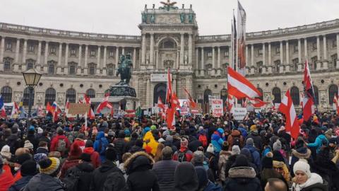 Protesters rally against Covid restrictions and mandatory vaccination outside the Hofburg Palace