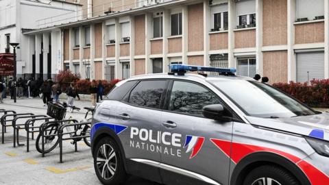 Police car parked in front of the Ravel highschool (lycee Ravel), in Paris, on 29 March 2024, following the resignation of the school's headmaster
