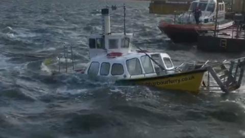 Ferry half-submerged in harbour.