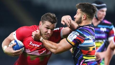 Hanro Liebenberg of Leicester Tigers is challenged by Rhys Webb of Ospreys