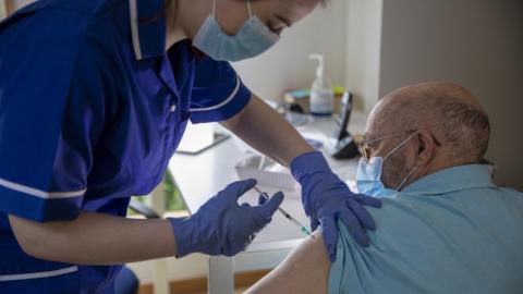 Older man being vaccinated