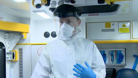 Paramedic Fraser Hutchison demonstrates the PPE ambulance crews must wear while responding to calls during the pandemic.