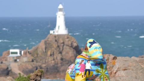 Gorilla statue in front of lighthouse