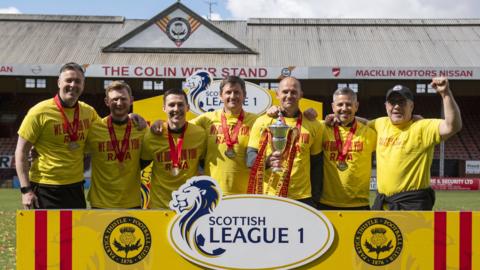 Manager Ian McCall celebrates last season's success with his coaching staff