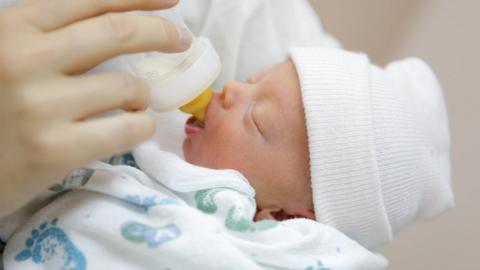 Bottle feeding a newborn baby