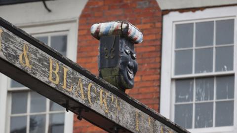 Sign above The Green Man and Black's Head Hotel