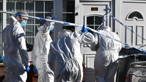 A forensics team at the family's home