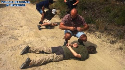 A Spanish police handout photo showing Jos Brech lying on a dirt road in handcuffs