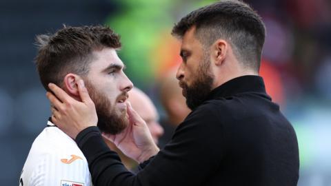 Ryan Manning (L) and Russell Martin talk at the end of a Swansea game