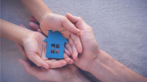 Child holding house cut out