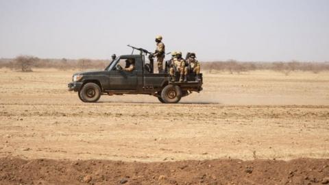 Burkina Faso soldiers patrol aboard a pick-up truck on the road from Dori to the Goudebo refugee camp, on February 3, 2020