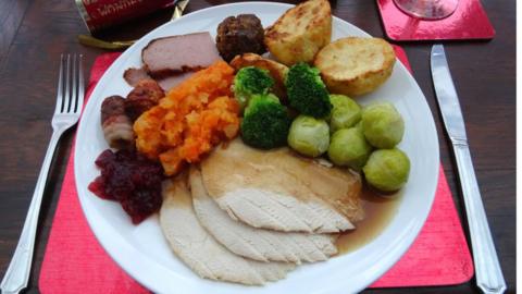 Traditional Christmas dinner with turkey, roast potatoes and Brussels sprouts.