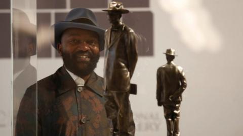 Samson Kambalu stands in front of his design for the Fourth Plinth