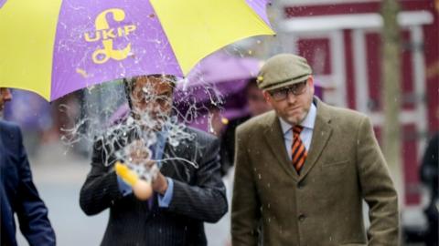 Paul Nuttall (right) and Nigel Farage dodging an egg