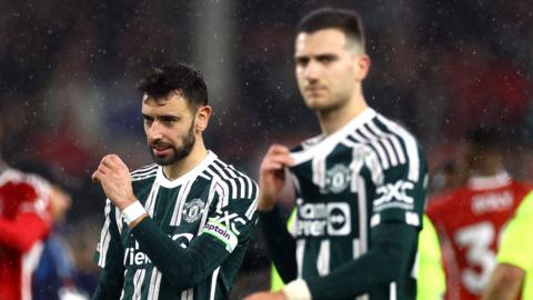 Bruno Fernandes and Diogo Dalot look dejected after loss