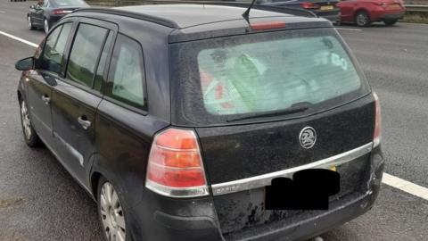 Vehicle on motorway hard shoulder filled with luggage in the rear