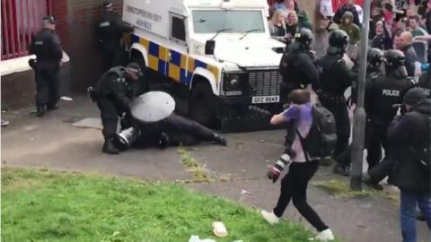 An injured police officer on the ground