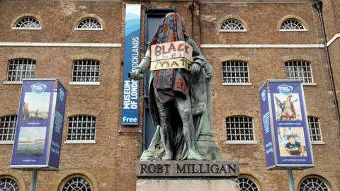 Robert Milligan statue covered for protest