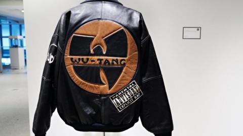 :"Uncle" Ralph McDaniels' original WU-TANG CLAN PARENTAL ADVISORY jacket is displayed during a preview at Sotheby's for their Inaugural HIP HOP Auction on September 12, 2020 in New York City