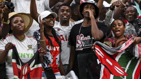 Fans of Kenya cheer their side on from the stands