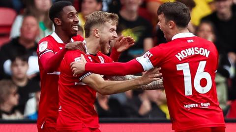 Riley McGree scored twice and celebrates one of his goals with teammates Jonny Howson and Isaiah Jones