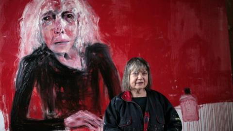 Shani Rhys James pictured in front of a painting depicting her mother