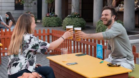 People drinking outside in London