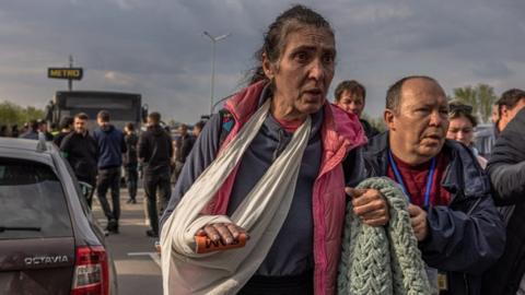 n injured woman walks after arriving on a bus which brought evacuated people from the steel plant Azovstal, Mariupol city and the surrounding areas, at the evacuation point in Zaporizhzhia, Ukraine, 03 May 2022