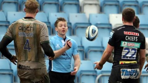 Referee Christophe Ridley explains his decision to Exeter's Joe Simmonds (22)