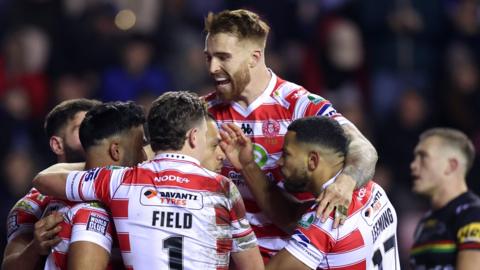Kruise Leeming of Wigan Warriors celebrates scoring a try during the Betfred Super League Final match between Wigan Warriors v Catalans Dragons at DW Stadium on February 24, 2024 in Wigan, England.
