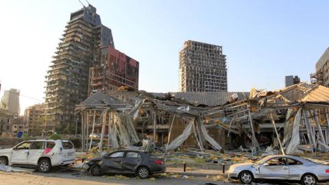 Damaged vehicles and buildings are seen near the site of the blast in Beirut's port area, Lebanon August 5, 2020