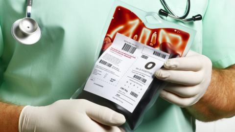 Doctor holding bag of blood